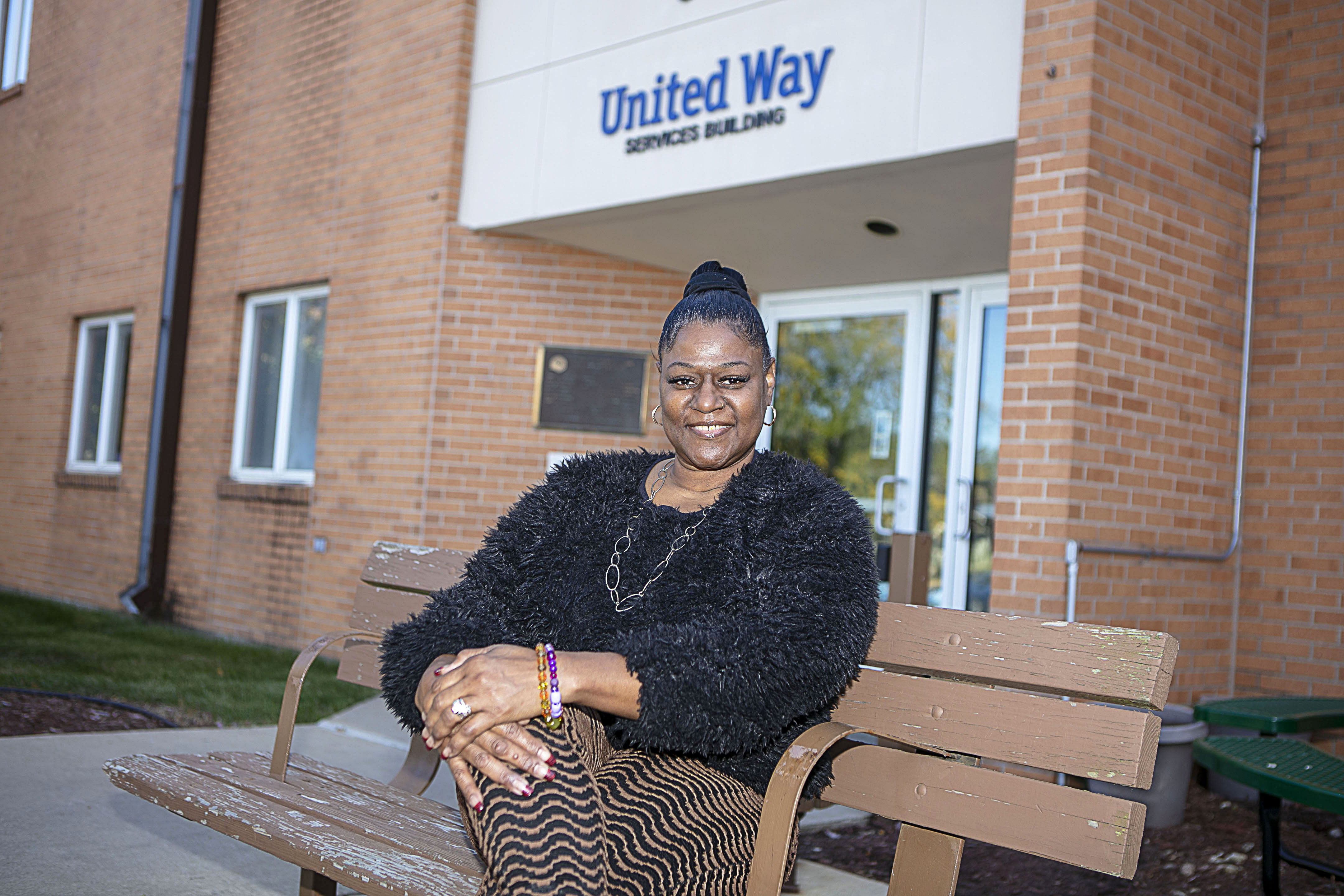Photo of a Black woman sitting outside the United Way office building