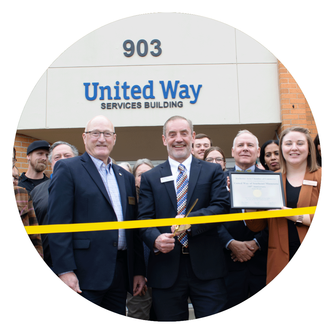 President Jerome Ferson cutting centennial ribbon in front of United Way building.
