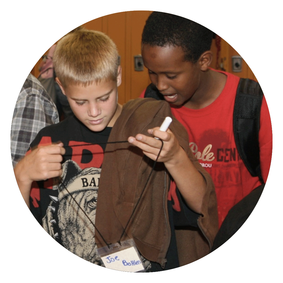 Two young boys writing name tags during their first day of school.